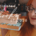a ginger girl holding up a stack of books
